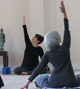 Women doing yoga stretches.