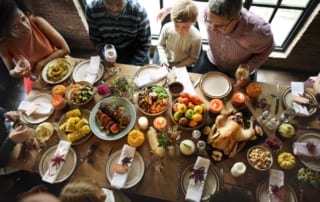 Overhead view of Thanksgiving dinner table with family