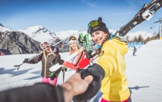 Women on mountain with skis