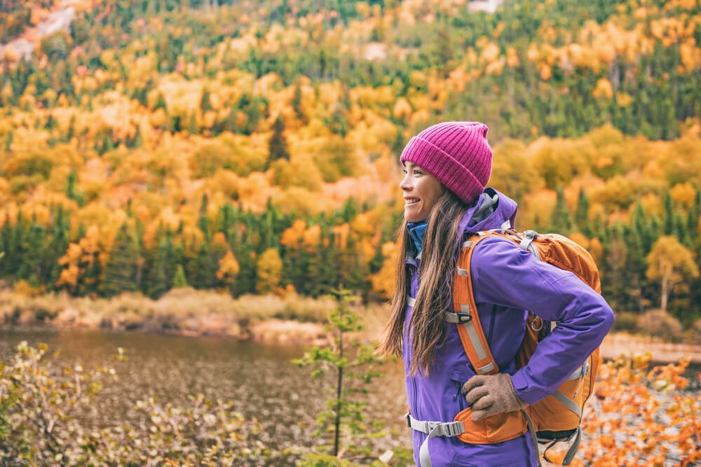 A woman out hiking in Upstate New York in the fall.