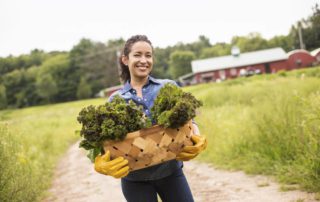 A woman with a basket of produce at one of the farms in Upstate New York.