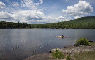 A person out kayaking, one of the best outdoor activities in the Catskills.