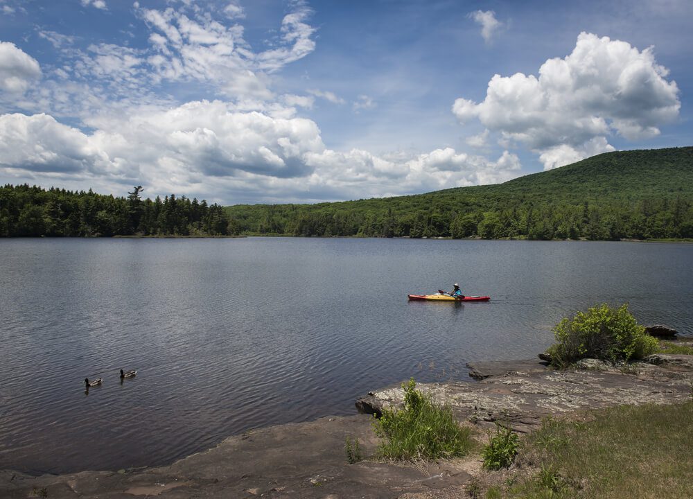 A person out kayaking, one of the best outdoor activities in the Catskills.