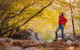 A woman hiking in the Catskills, one of the top results when searching for what to do on a solo trip.