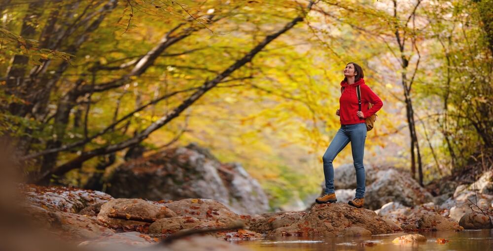 A woman hiking in the Catskills, one of the top results when searching for what to do on a solo trip.