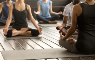 People doing yoga during a digital detox retreat.